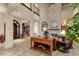 Grand foyer features soaring ceilings, stone pillars, elegant staircase, and fireplace in the great room at 705 Riviera Dunes Way, Palmetto, FL 34221