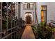 Elegant front entrance with brick pathway, arched doorway, and second story balcony at 705 Riviera Dunes Way, Palmetto, FL 34221