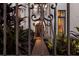 Elegant front entrance with brick pathway, wrought iron gate and lush landscaping at 705 Riviera Dunes Way, Palmetto, FL 34221