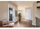 Upstairs hallway with hardwood floors, glass balcony door, and comfortable seating at 705 Riviera Dunes Way, Palmetto, FL 34221