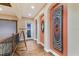 Second floor hallway with hardwood floors, sunset views, and uniquely decorated walls at 705 Riviera Dunes Way, Palmetto, FL 34221