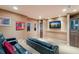 Entertainment room features theater seating, built-in cabinetry, and a large flatscreen TV for an immersive viewing experience at 705 Riviera Dunes Way, Palmetto, FL 34221