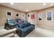 Home theater room with plush seating and tiered levels for an immersive movie experience at 705 Riviera Dunes Way, Palmetto, FL 34221