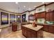 Open kitchen featuring a central island, stainless appliances, and sunset views at 705 Riviera Dunes Way, Palmetto, FL 34221