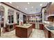 Spacious kitchen with custom cabinets, large island, and breathtaking water views at 705 Riviera Dunes Way, Palmetto, FL 34221