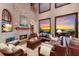 Bright living room features soaring ceilings, fireplace with stone mantle and large window with sunset views at 705 Riviera Dunes Way, Palmetto, FL 34221