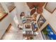 Aerial view of an open-concept living room with fireplace, leather sofas, and oversized ceiling fan at 705 Riviera Dunes Way, Palmetto, FL 34221