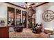 Cozy living room with spiral staircase, ceiling fan, and views of the water through large windows at 705 Riviera Dunes Way, Palmetto, FL 34221