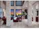 Bright living room featuring soaring ceilings, exposed brick pillars, and a large window with sunset views at 705 Riviera Dunes Way, Palmetto, FL 34221