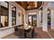 Alfresco dining on the covered patio featuring a ceiling fan and wrought iron railings at 705 Riviera Dunes Way, Palmetto, FL 34221