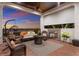 Outdoor patio with fireplace, seating area, and a hanging chair to create a relaxing space to enjoy the sunset at 705 Riviera Dunes Way, Palmetto, FL 34221