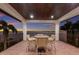 Enjoy outdoor dining on the covered patio with serene water views and seating for four at 705 Riviera Dunes Way, Palmetto, FL 34221