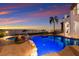 A picturesque pool area with a relaxing fire pit and stunning water views at 705 Riviera Dunes Way, Palmetto, FL 34221