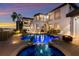 Sparkling pool area featuring led lighting, a lovely dolphin fountain, and inviting lounge chairs at 705 Riviera Dunes Way, Palmetto, FL 34221