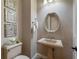Chic powder room featuring designer mirror and fixtures at 705 Riviera Dunes Way, Palmetto, FL 34221