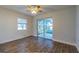 A sun-filled bedroom boasts patio access and beautiful hardwood-style flooring at 7150 E Bank Dr # 101, Tampa, FL 33617