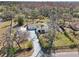 Stunning aerial view of a landscaped home with an extra-long driveway and lots of surrounding trees at 8376 Sycamore Dr, New Port Richey, FL 34654