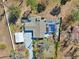Aerial view of the property with a pool, backyard, driveway and lush greenery at 8376 Sycamore Dr, New Port Richey, FL 34654