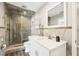Updated bathroom featuring a tiled walk-in shower, quartz vanity, and glass shelves at 8376 Sycamore Dr, New Port Richey, FL 34654