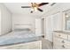 Bedroom with a bed, a ceiling fan, two windows, and closet space at 8376 Sycamore Dr, New Port Richey, FL 34654