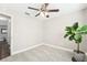 Bright bedroom featuring neutral walls, carpet, ceiling fan, and natural light at 8376 Sycamore Dr, New Port Richey, FL 34654