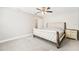 Bright bedroom with a bed, ceiling fan, neutral walls and ensuite bathroom access at 8376 Sycamore Dr, New Port Richey, FL 34654