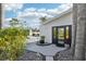 Exterior entrance with a glass front door, decorative landscaping, and a well-maintained walkway at 8376 Sycamore Dr, New Port Richey, FL 34654