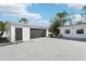 Spacious detached garage and driveway showcasing ample parking and storage space for vehicles and equipment at 8376 Sycamore Dr, New Port Richey, FL 34654