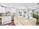 Open kitchen featuring granite countertops, a large island, and sliding doors to outdoor living space at 8376 Sycamore Dr, New Port Richey, FL 34654