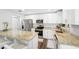 Bright kitchen featuring stainless steel appliances, granite counters, and convenient breakfast bar at 8376 Sycamore Dr, New Port Richey, FL 34654