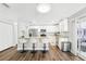 Bright kitchen view features granite counters, stainless appliances, hardwood floors and breakfast bar at 8376 Sycamore Dr, New Port Richey, FL 34654