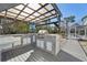 Inviting outdoor kitchen with a bar, grill, and outdoor television at 8376 Sycamore Dr, New Port Richey, FL 34654
