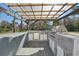 Inviting outdoor kitchen with a bar, grill, and outdoor television at 8376 Sycamore Dr, New Port Richey, FL 34654