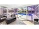 Cozy sunroom featuring white tiled floors and views of the pool at 8376 Sycamore Dr, New Port Richey, FL 34654