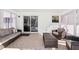 Enclosed sunroom with brick floors, neutral walls and comfortable seating at 8376 Sycamore Dr, New Port Richey, FL 34654
