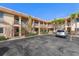 Exterior of a two-story condo building with parking and palm trees at 9060 Blind Pass Rd # 28, St Pete Beach, FL 33706