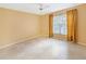 Bright bedroom with tile flooring, a ceiling fan, and natural light streaming through the window at 10346 Carrollwood Ln # 171, Tampa, FL 33618