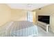 Cozy bedroom featuring a comfortable bed, tile flooring, and a closet with plenty of storage space at 10346 Carrollwood Ln # 171, Tampa, FL 33618