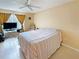 Relaxing bedroom with tile flooring, a ceiling fan, and a comfortable bed near the window at 10346 Carrollwood Ln # 171, Tampa, FL 33618