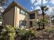 Back exterior of home with a patio, screened in porch and tropical landscaping at 10346 Carrollwood Ln # 171, Tampa, FL 33618