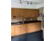 Functional kitchen featuring wood cabinets, granite countertops, and a stainless steel refrigerator at 10346 Carrollwood Ln # 171, Tampa, FL 33618