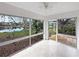 Enclosed lanai featuring tile flooring, a ceiling fan, and a beautiful pond view at 10346 Carrollwood Ln # 171, Tampa, FL 33618