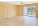 Bright living room featuring tile flooring, a ceiling fan and sliding glass doors to the lanai with a pond view at 10346 Carrollwood Ln # 171, Tampa, FL 33618