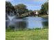 This stunning community features a tranquil pond with a water fountain and walking bridge at 10346 Carrollwood Ln # 171, Tampa, FL 33618