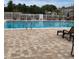 Outdoor pool area with lounge chairs and a fence at 10346 Carrollwood Ln # 171, Tampa, FL 33618