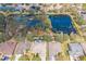 Aerial view of homes surrounding a pond with partial coverage of lily pads at 11713 Summer Springs Dr, Riverview, FL 33579
