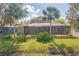Backyard view features a screen enclosed pool with lush landscaping and shade trees at 11713 Summer Springs Dr, Riverview, FL 33579