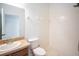 Bathroom featuring a vanity, toilet, and shower with a white tile surround at 11713 Summer Springs Dr, Riverview, FL 33579
