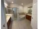 Well-lit bathroom with double sinks, soaking tub, and a separate glass-enclosed shower, for ultimate relaxation at 11713 Summer Springs Dr, Riverview, FL 33579