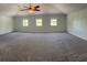Spacious bedroom featuring neutral carpet, vaulted ceiling, and natural light from three windows at 11713 Summer Springs Dr, Riverview, FL 33579